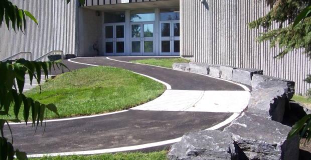 Wheelchair accessible ramp leading to office entry door