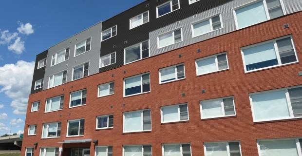 A five story apartment building with brick exterior.