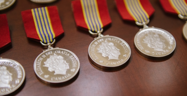 A row of round medallions with the Queens face embossed on them.