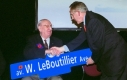 Mayor and guests holding a street sign 