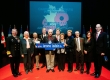 Mayor and guests holding a street sign 