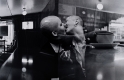 Double exposure black and white photograph of two people kissing