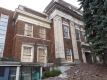 This Classical revival style building is brown brick with stone detailing and is located at 330 Gilmour Street in the Centretown Heritage Conservation District.